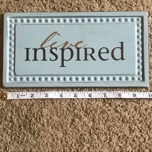 Blue “Live Inspired” sign